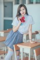 A woman in a school uniform posing for a picture.