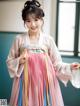 A young girl wearing a pink and blue hanbok.