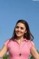 a woman in a pink shirt posing for a picture