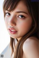 A close up of a woman with long brown hair.