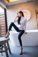 A woman sitting on a bathtub in a bathroom.